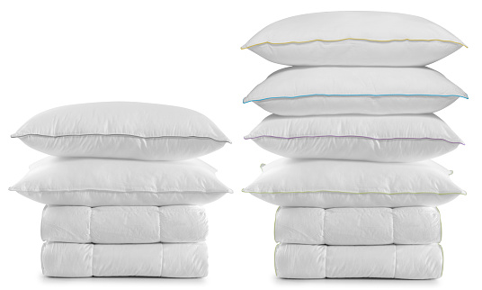 Stack of pillows on duvets over white background. Soft feather applied.