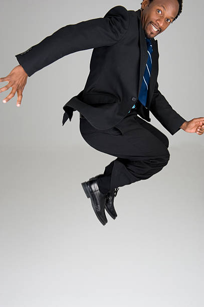 istock Black Business Man Jumps in a Tight Composition 471256857