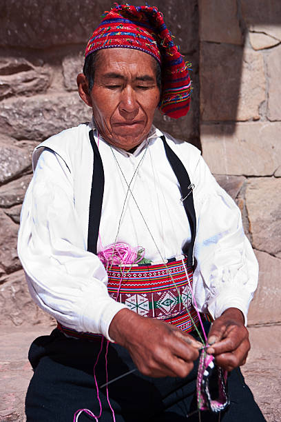 istock Man knitting on Taquile Island in Peru 471257341