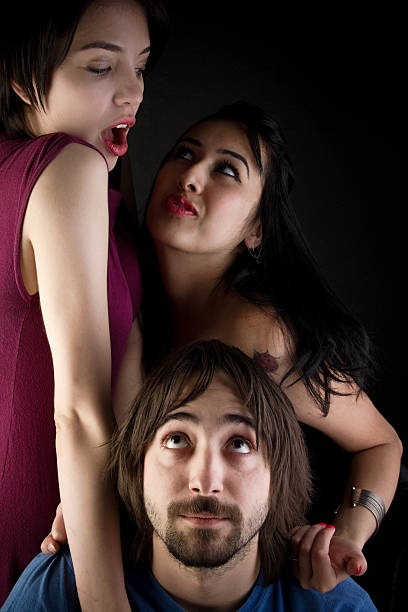 istock Two women is standing by a man watching them 471257611