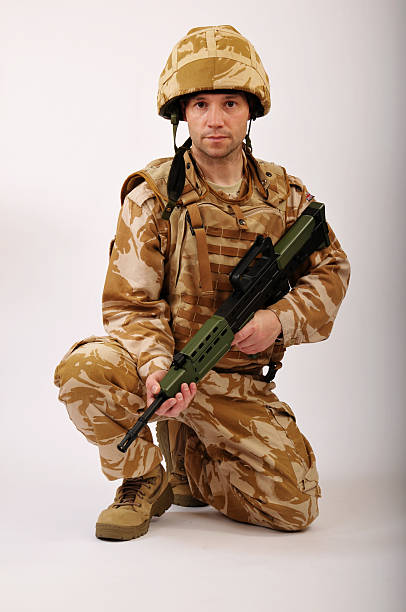 istock Soldier Kneeling With Rifle 471258241
