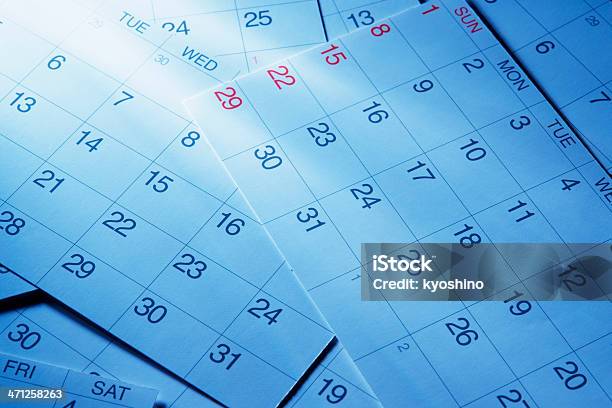 Blue Tinted Image Of Calendars With Light Rays Stock Photo - Download Image Now - Calendar, Backgrounds, Planning