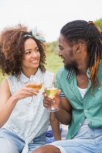 istock Young couple on a picnic drinking wine 471258494