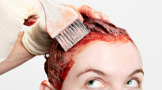 Permanent hair dye being applied with a watchful eye.