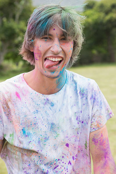 istock Young man having fun with powder paint 471258822