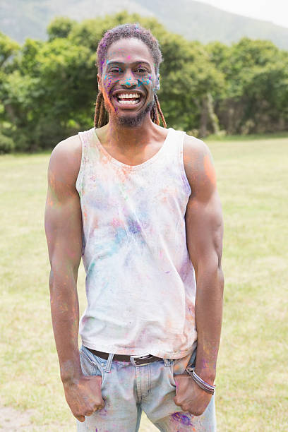 istock Young man having fun with powder paint 471258838