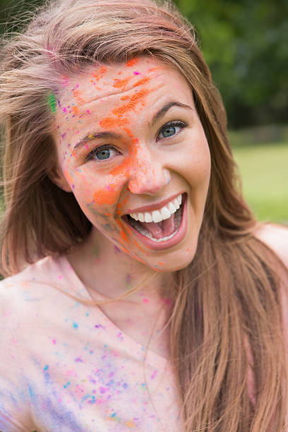 istock Young woman having fun with powder paint 471258870