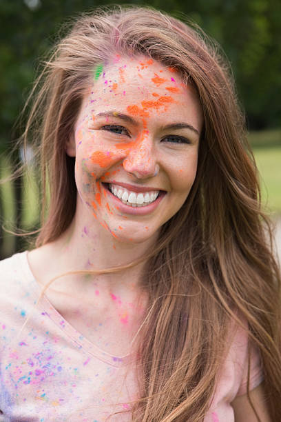 istock Young woman having fun with powder paint 471259232