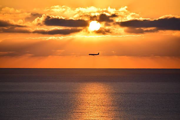 Plane over the Mediterranean Sea at Sunrise stock photo