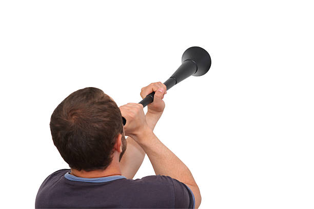 Soccer supporter blowing a Vuvuzela stock photo