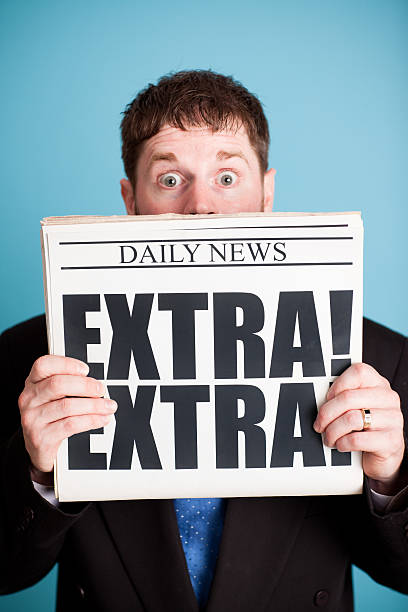 istock Surprised Businessman Holding Newspaper with Extra! Headline 471261995
