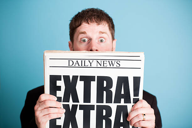istock Surprised Businessman Holding Newspaper with Extra! Headline 471262269