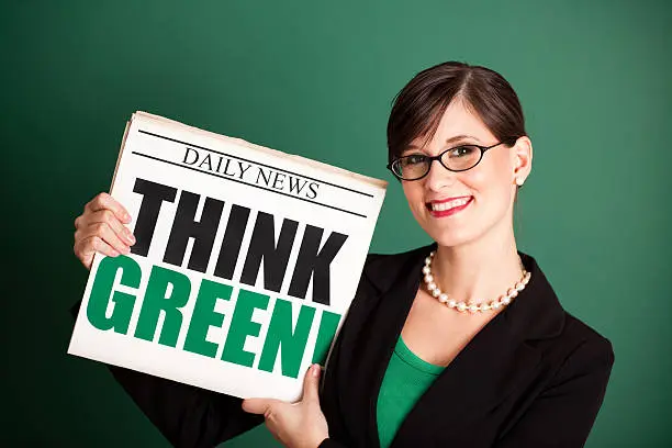 Photo of Happy Young Business Woman Holding Newspaper Headlined 