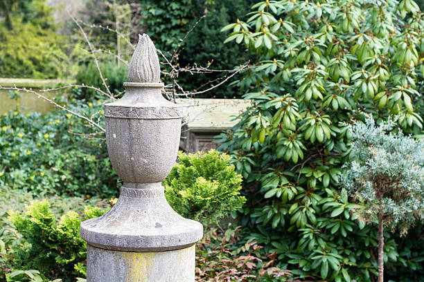 abstracted torchlight from stone as a symbol of eternal life, garden sculpture in a park or cemetery