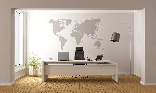 Minimalist office with desk and world map on wall - 3D Rendering