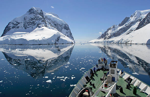 Antarctic Cruise A small cruise ship makes passage through the Lemaire Channel in Antarctica antarctic peninsula photos stock pictures, royalty-free photos & images