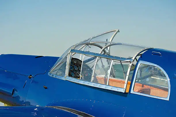 Part of body, wings and cockpit of a vintage airplane - a Messerschmitt 108 from the 1930s.