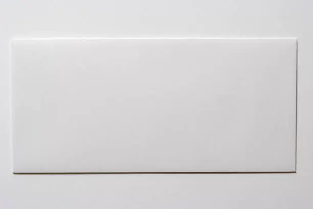 Photo of Isolated shot of blank white envelope on white background