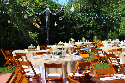 Seating for a party, with tables and chairs and decorations, all set up