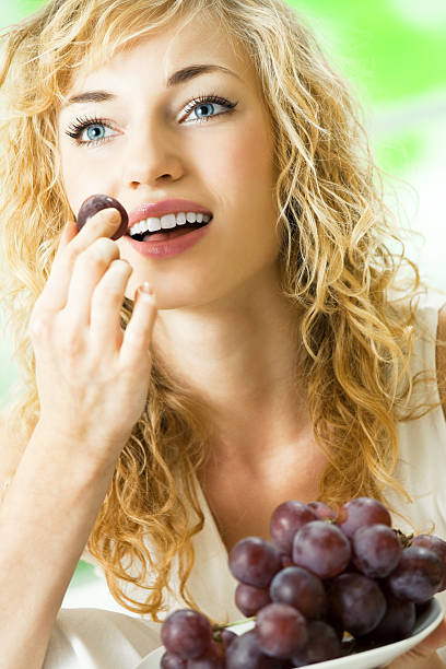 istock Young happy woman with plate of grape 471270471