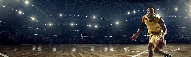 istock Panorama of basketball stadium under lights with player 471271310