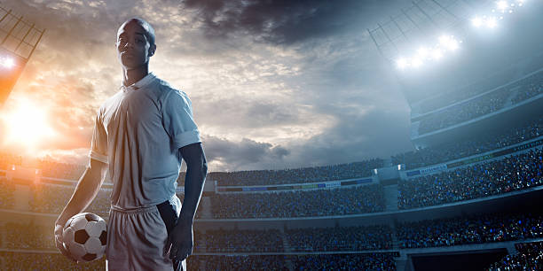istock Soccer player kicking ball in stadium 471271466