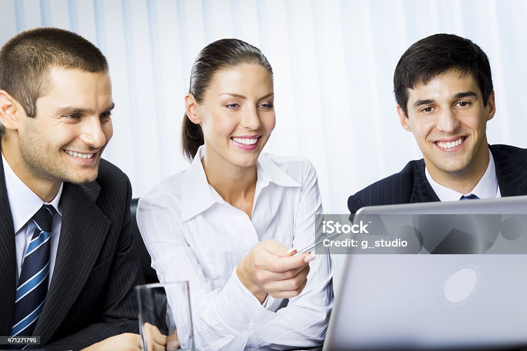 Três empresários trabalhando com o laptop no escritório - Foto de stock de Adulto royalty-free