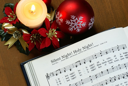 Detail of songbook with christmas carols  and christmas decorations.      