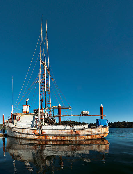 An old fishing boat, covered with rust.