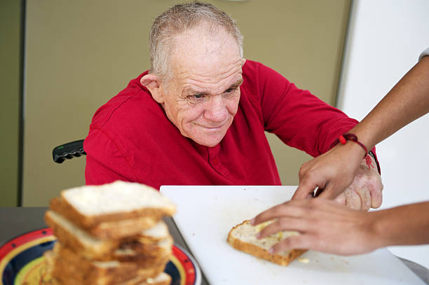 istock Senior Man with a disability making sandwiches 471274861