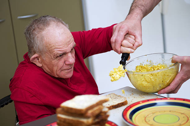 senior hombre con discapacidad que han contribuido en la cocina - occupational therapy fotografías e imágenes de stock