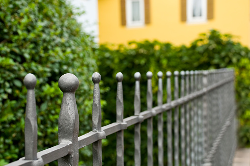 Iron fence painted in silver color. Focus on foreground. Converted from Nikon RAW, Adobe RGB. 