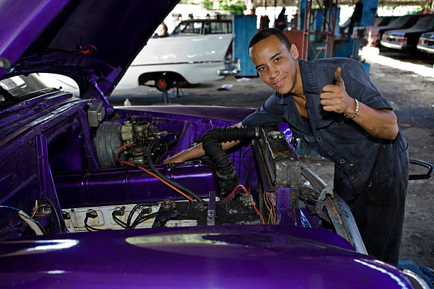 Cuban repairman working on a car