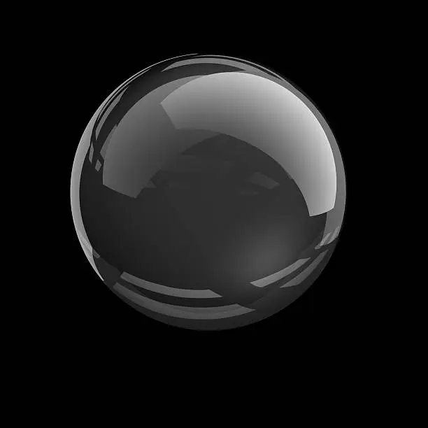 Photo of Clear glass sphere on black background