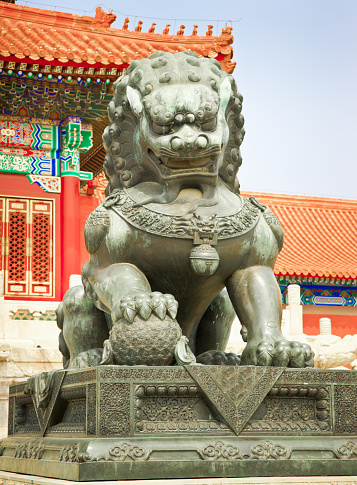Chinese guardian lion  in front of Gate of Supreme Harmony in Forbidden City, Beijing. The lions are always created in pairs, with the male playing with a ball and the female with a cub.