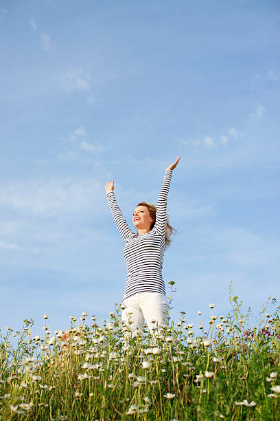 istock Happy woman in flower field 471282538