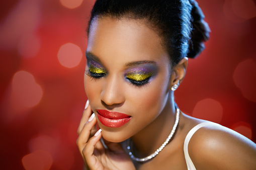 Beautiful African woman in red glitter background. Can be used for Christmas or Valentine themes.