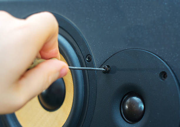 istock Male hand fixing professional studio monitor. 471284148