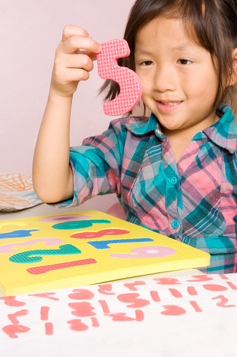 Chinese little girl holds up the number 