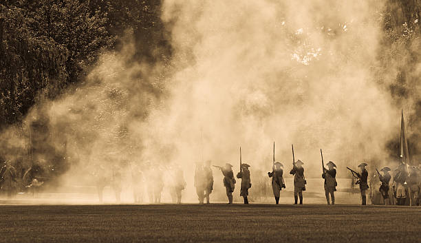 silouettes in cannon smoke II an "antique" looking image of US Revoulutionary war riflemen silouetted in the smoke of the cannon barrage fired moments before. makes a great background with plenty of copy space. battle reenactment stock pictures, royalty-free photos & images