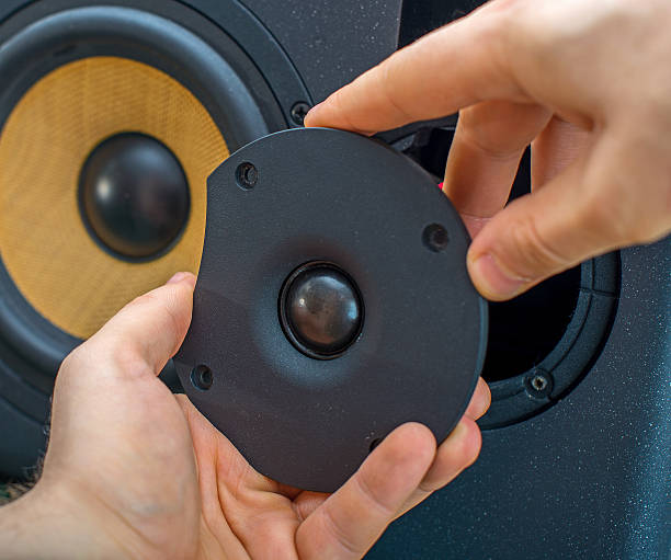 istock Male hand connecting professional studio monitor speaker. 471286546