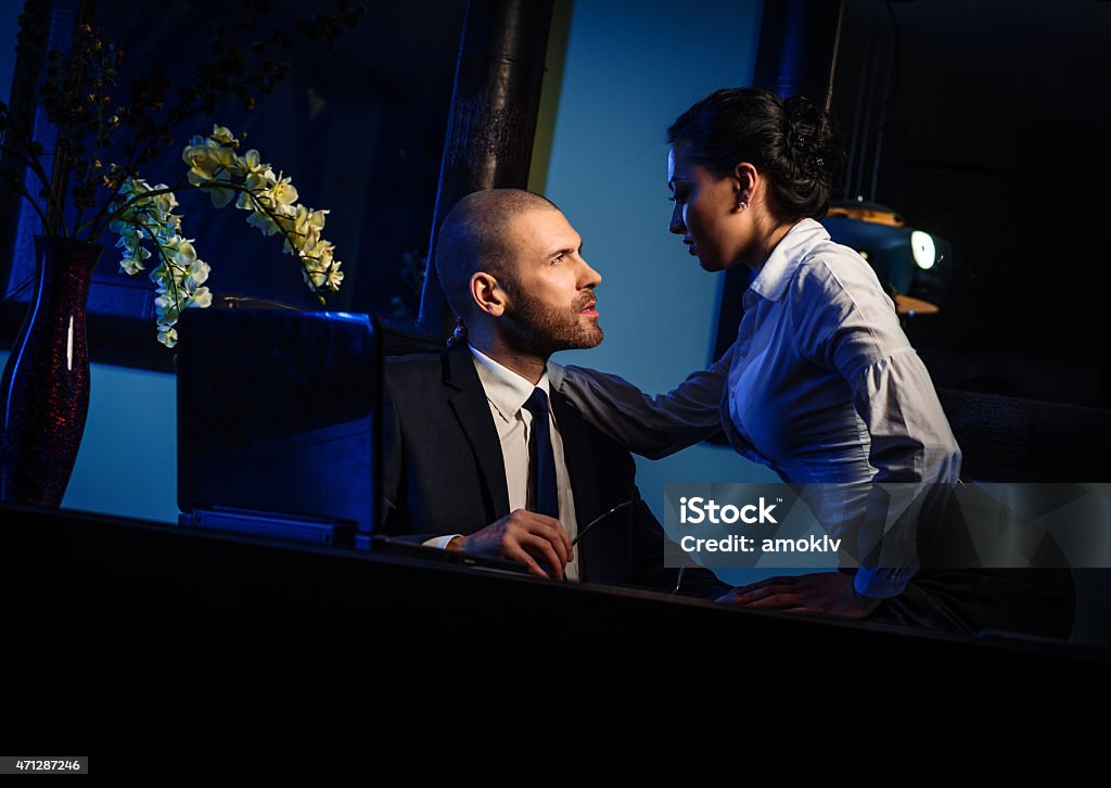 Couple indoors Couple indoors. Sensual brunette seduces handsome businessman. Office romance concept 2015 Stock Photo