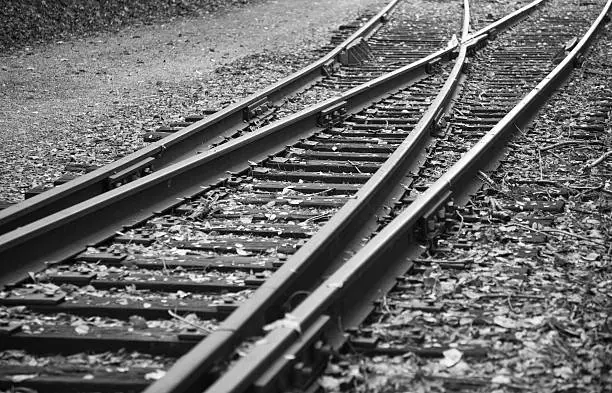 Photo of Railroad Tracks Branching in Two Directions - Black and White