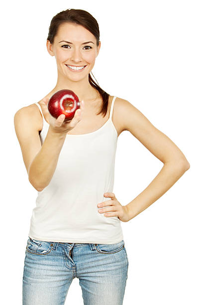 istock Healthy lifestyle. Beautiful brunette holding red apple 471287629