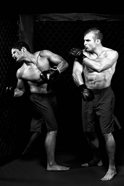 istock Mixed martial artists fighting - punching 471288149
