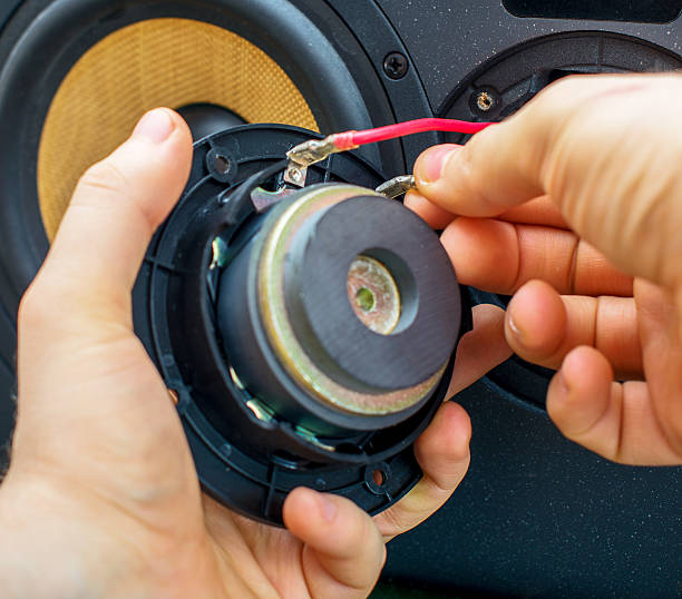 istock Male hand connecting professional studio monitor speaker. 471289400