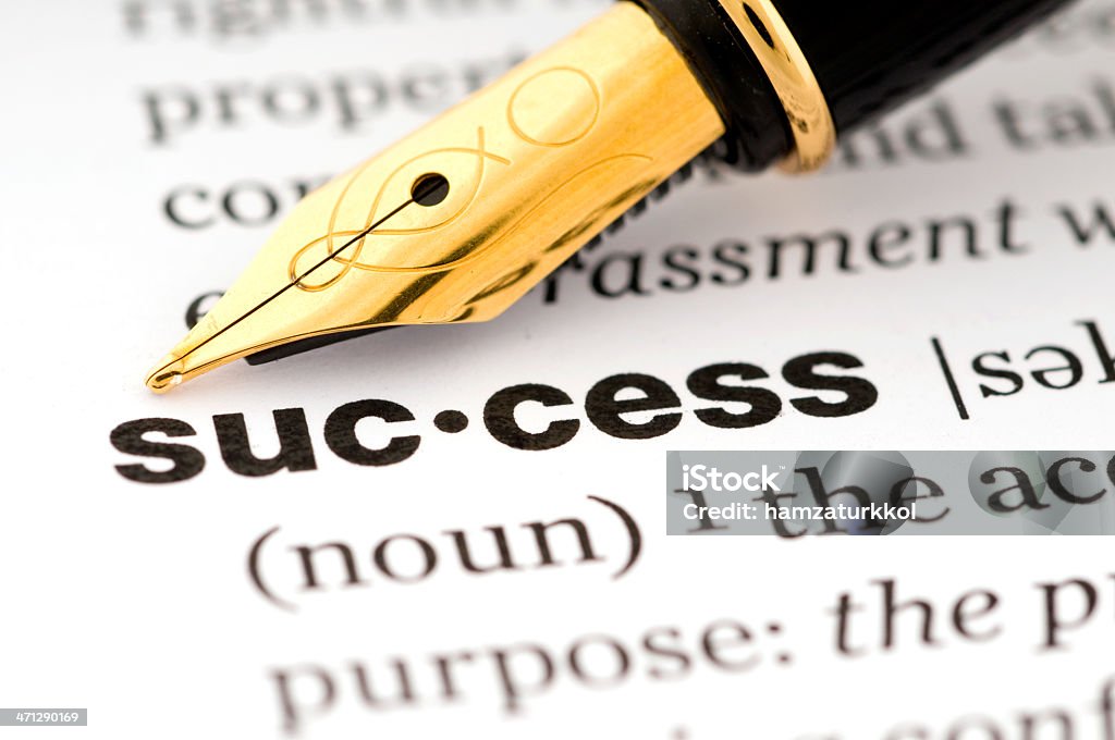 Pen pointing to success in a dictionary Closeup of a dictionary and the word "success" with fountain pen Black Color Stock Photo