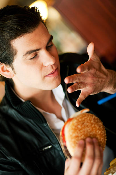 człowiek w restauracji jedzenie hamburgera - finger licking zdjęcia i obrazy z banku zdjęć