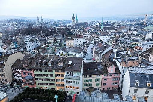 View from Tower of Urania Sternwarte of Zurich, Switzerland, the public observatory in the Lindenhof quarter towards Lindenhof, the churches and the Lake. The freezing cold winter morning of January 4, 2011 is quite dark during the partial solar eclipse. 