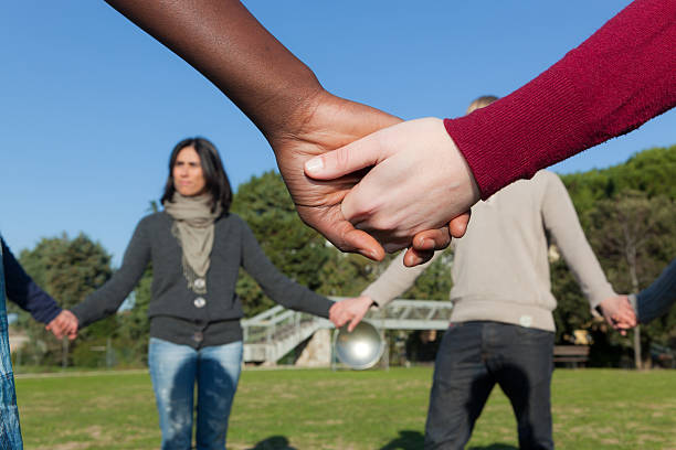 istock Multiracial Young People Holding Hands in a Circle 471290885